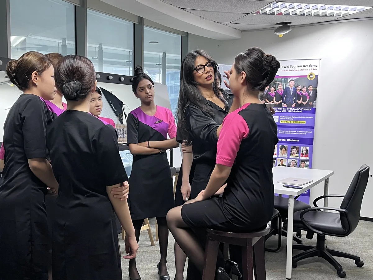 IETA trainer leading a grooming and deportment session with students in uniform